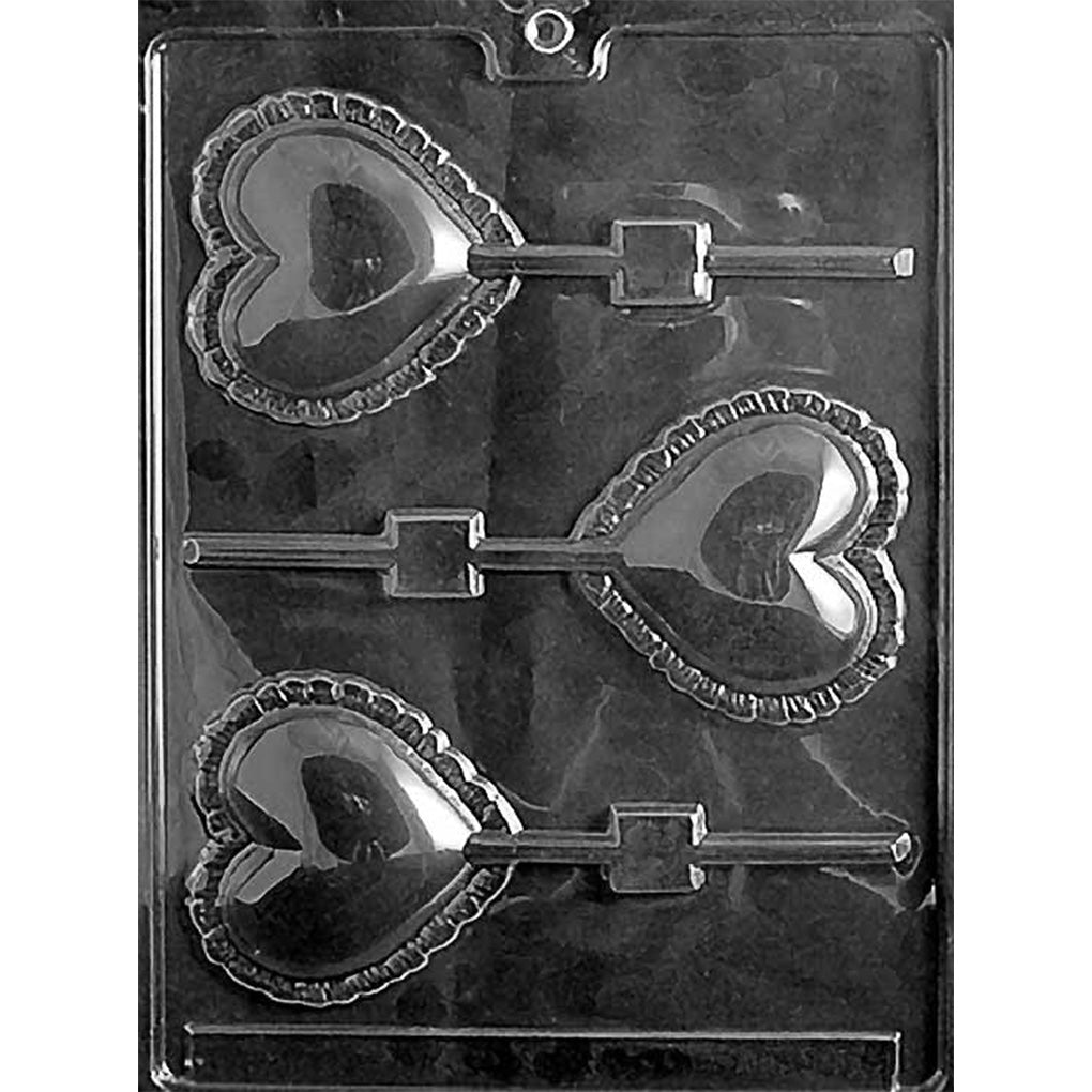Clear Large Lace Heart Chocolate Lollipop Mold photographed against a black background with three heart cavities featuring smooth centers, ornate lace-style borders, and stick channels.