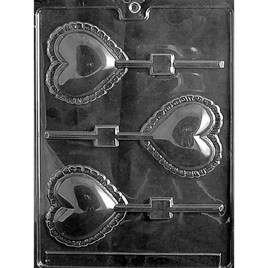 Clear Large Lace Heart Chocolate Lollipop Mold photographed against a black background with three heart cavities featuring smooth centers, ornate lace-style borders, and stick channels.