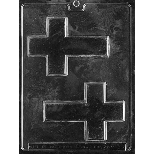 Clear plastic chocolate mold photographed on a black background, showing two large cross-shaped cavities with squared arms and raised detail.