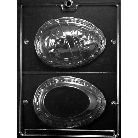Clear plastic 3D Easter egg chocolate mold with two large egg halves: one embossed with scenes (rabbit painting a rabbit and a woman with stroller) and a striped name panel, plus one smooth egg half for joining into a hollow egg.