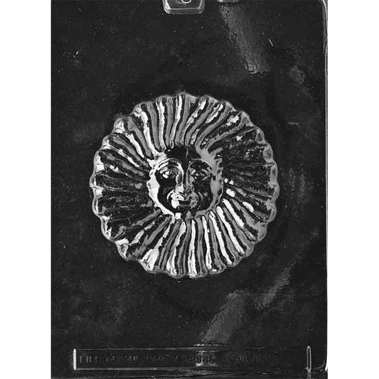 Clear plastic large sunface chocolate mold with one round cavity featuring a smiling face in the center and raised, wavy sun rays around the edge on a dark background.