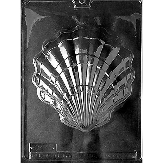 Clear plastic chocolate mold with one large scallop shell cavity featuring deep ribbed lines and a scalloped edge, shown on a dark background.