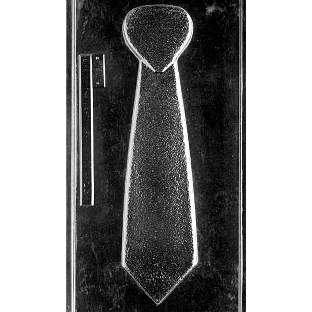 Clear plastic chocolate mold photographed on a black background with a large necktie-shaped cavity and a long narrow detail panel along the left side.