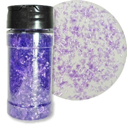Clear shaker bottle filled with lavender-purple edible glitter flakes beside a white round sample covered with scattered translucent lavender flakes.