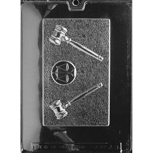 Clear plastic chocolate bar mold with one large rectangular cavity featuring two raised gavels and a round scales-of-justice emblem on a textured background.