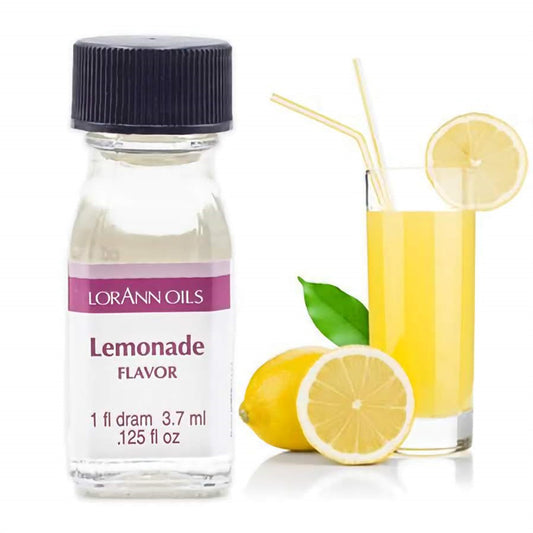 One-dram bottle of LorAnn Oils Lemonade Flavor beside a glass of yellow lemonade, fresh lemons, and a green leaf.