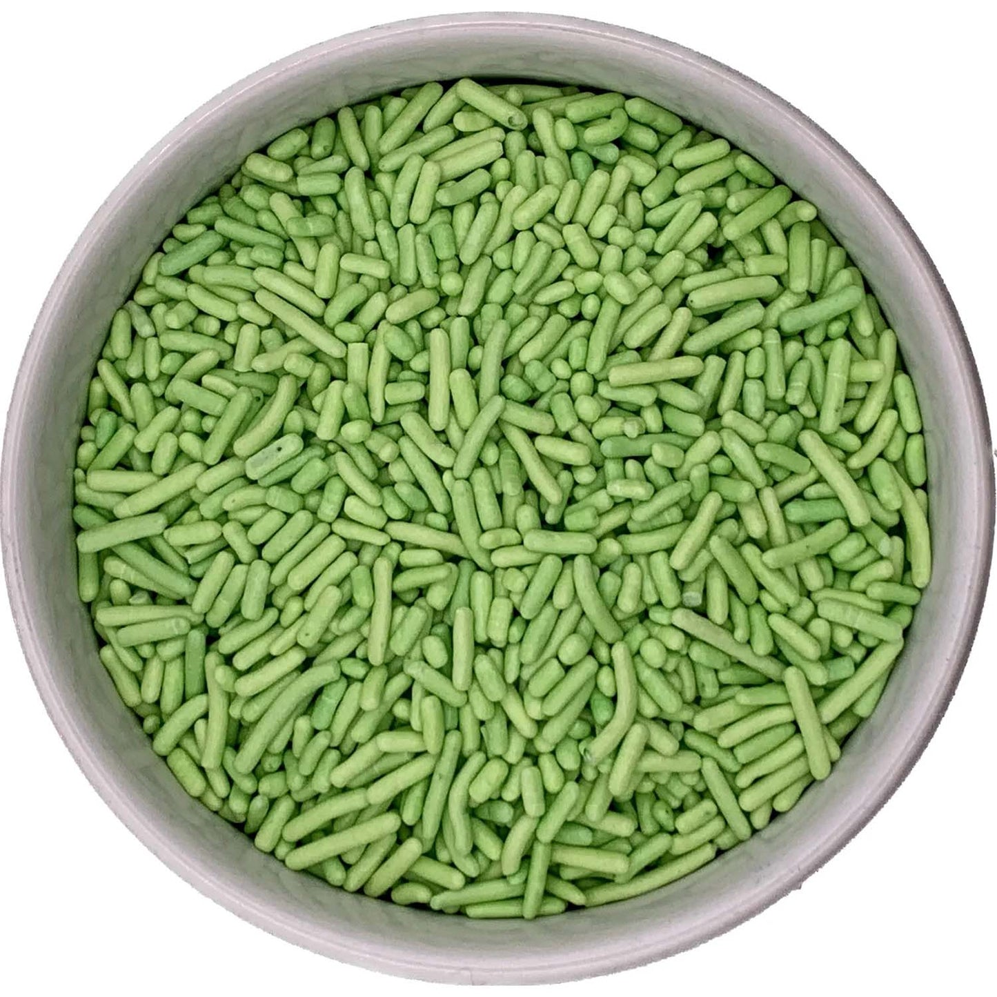 Top-down view of a round container filled with light green jimmies sprinkles, showing short rod-shaped pieces packed closely together.