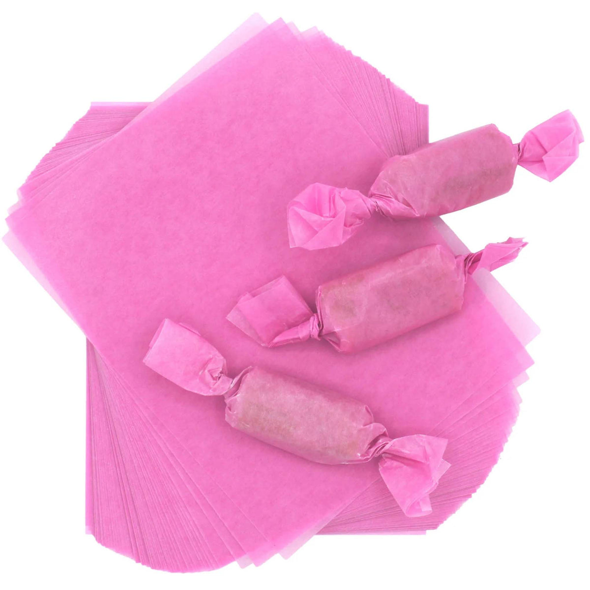 Three rectangular caramel pieces individually packaged in light pink wax candy wrappers with twisted ends, displayed over two fanned stacks of 4" x 5" wrapper sheets.
