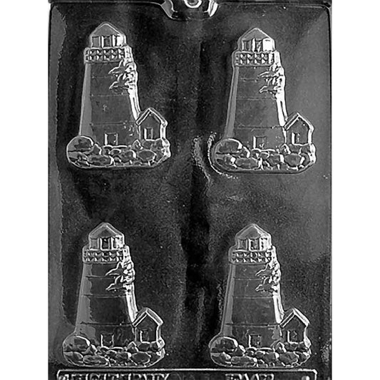 Clear plastic chocolate mold with four lighthouse-shaped cavities showing a tall lighthouse tower on a rocky shoreline with a small keeper’s house beside it.