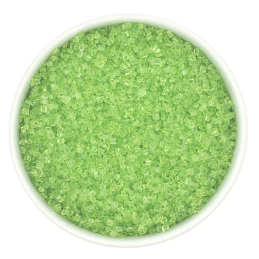 Bowl of lime green coarse sanding sugar crystals on a white background.