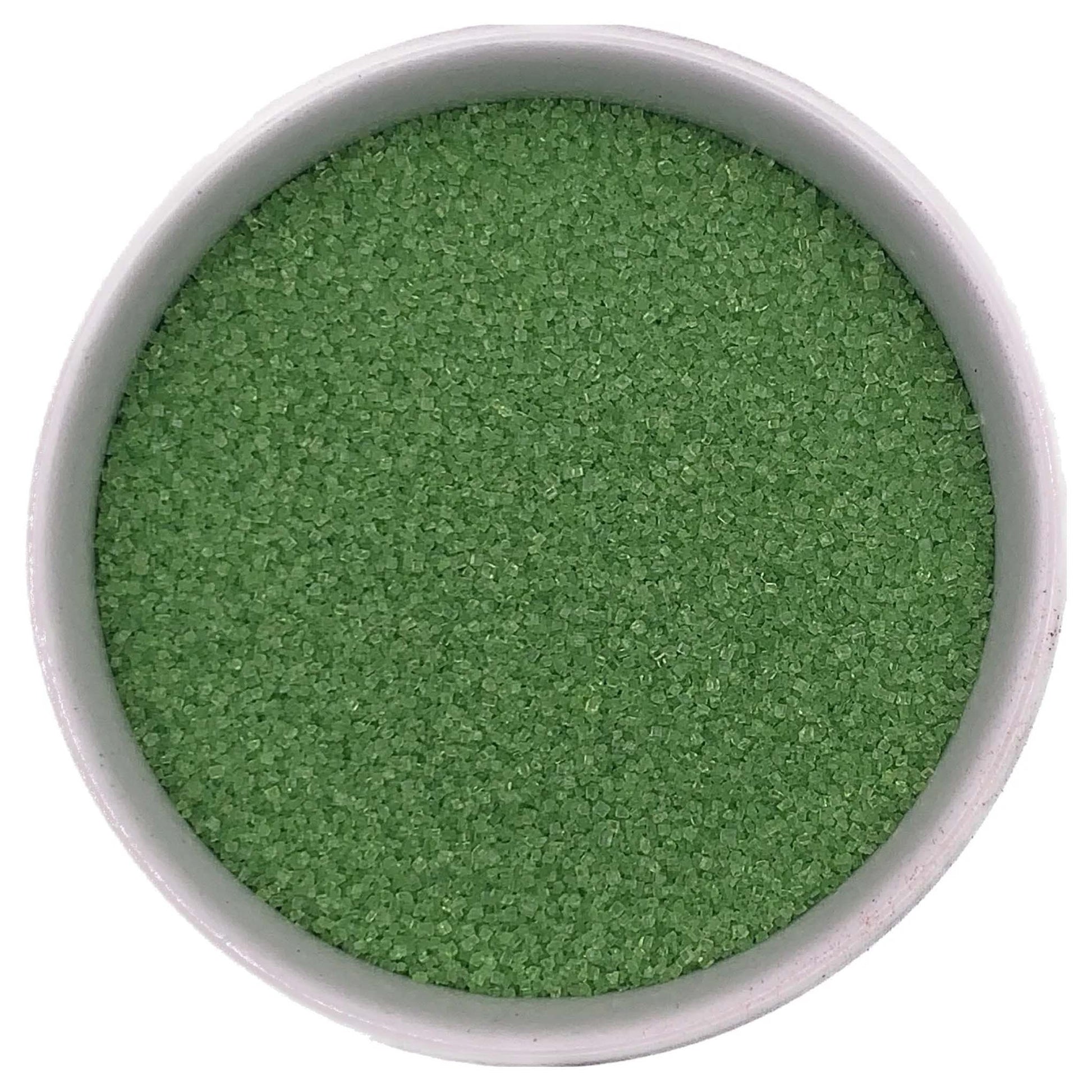 Lime green fine sanding sugar crystals in a white bowl on a white background.