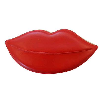 Decorated lips-shaped cookie covered in red icing with a smooth, glossy finish.