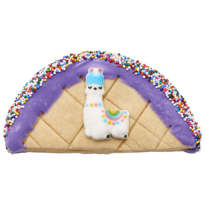 Decorated cookie taco with llama sugar decoration and rainbow nonpareils.