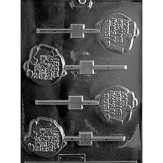 Clear chocolate lollipop mold with four round novelty cavities featuring raised “Lord, Help Me Hang in There” lettering and straight stick channels on a dark background.