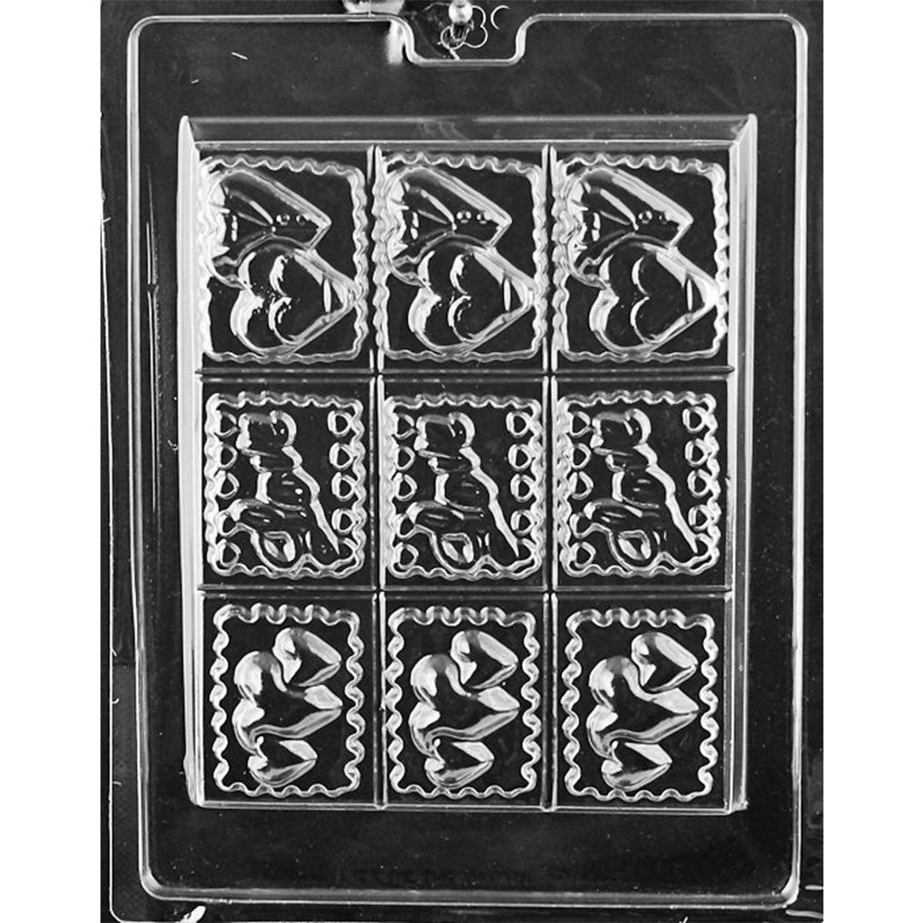 Clear chocolate mold with nine deep rectangular cavities arranged in a three-by-three grid, featuring assorted romantic designs with hearts, teddy bears, and scalloped borders.