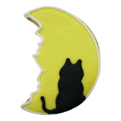 Decorated Man in the Moon cookie with a yellow icing base and a black cat silhouette.