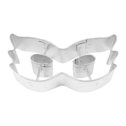 Metal Mardi Gras mask cookie cutter featuring eye cutouts and a decorative mask shape.