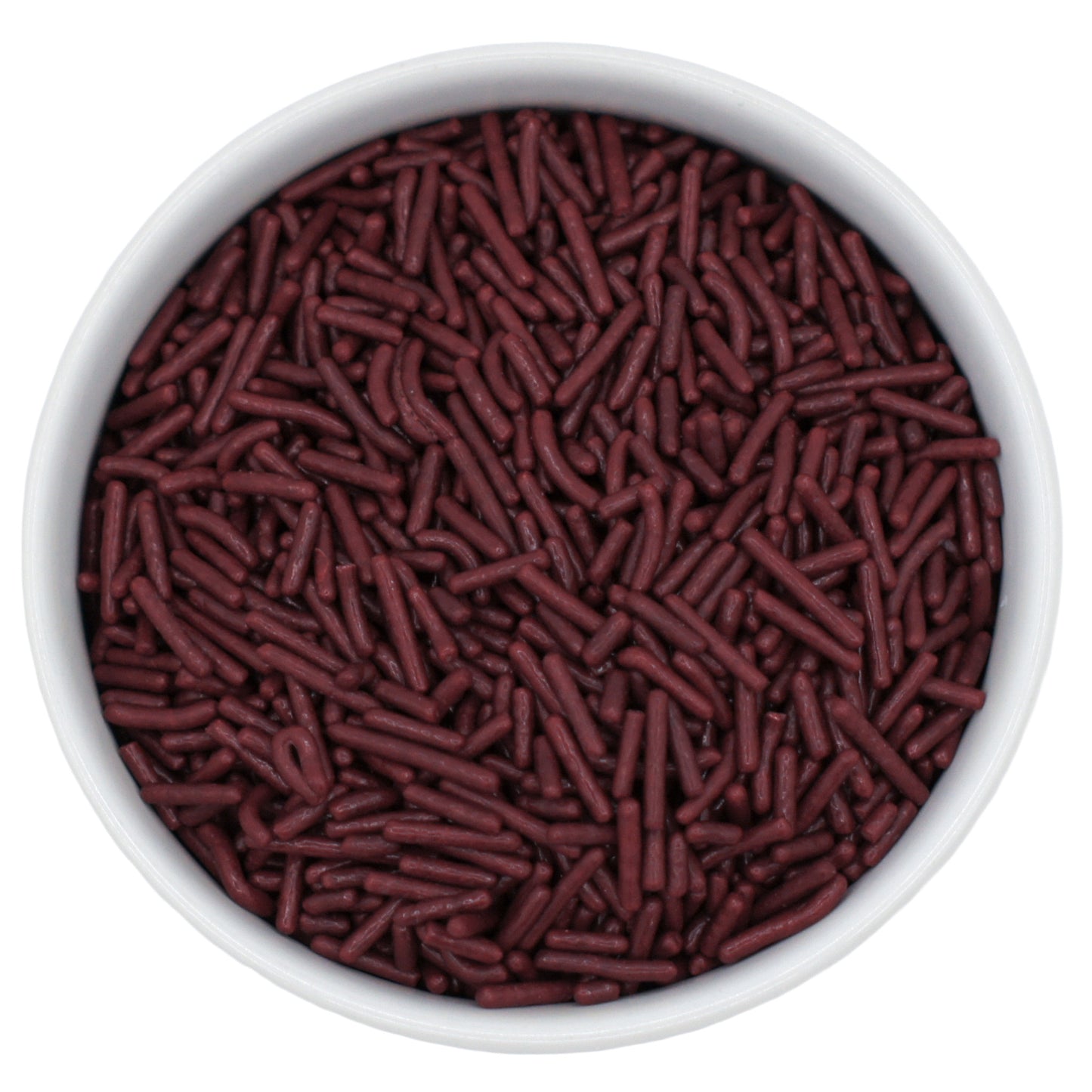 Top-down close-up of a white bowl filled with maroon jimmies sprinkles.