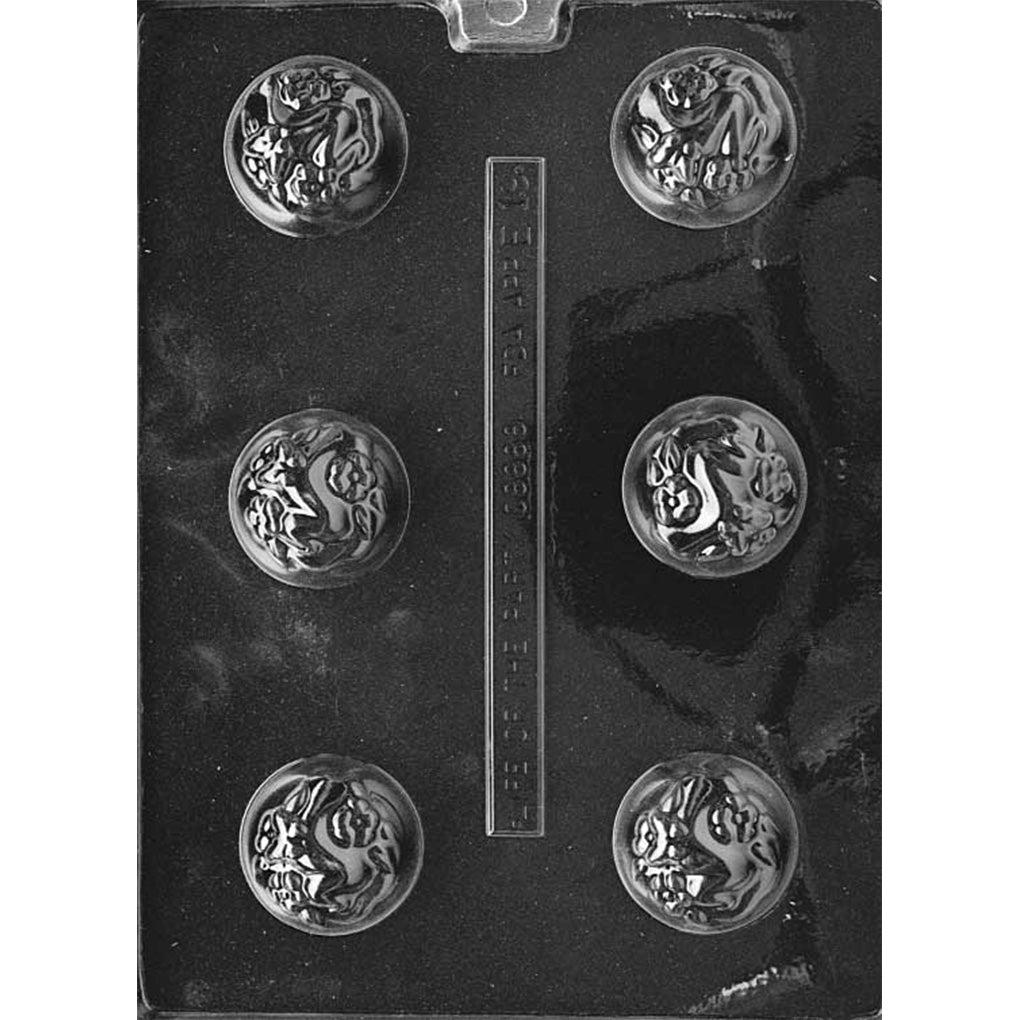 Clear plastic chocolate mold with six round domed cavities, each featuring raised floral and butterfly decorations on the top surface.