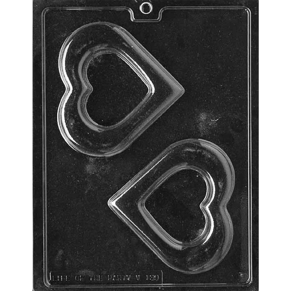 Clear chocolate mold with two medium heart-shaped cavities featuring smaller heart-shaped openings in the centers on a dark background.