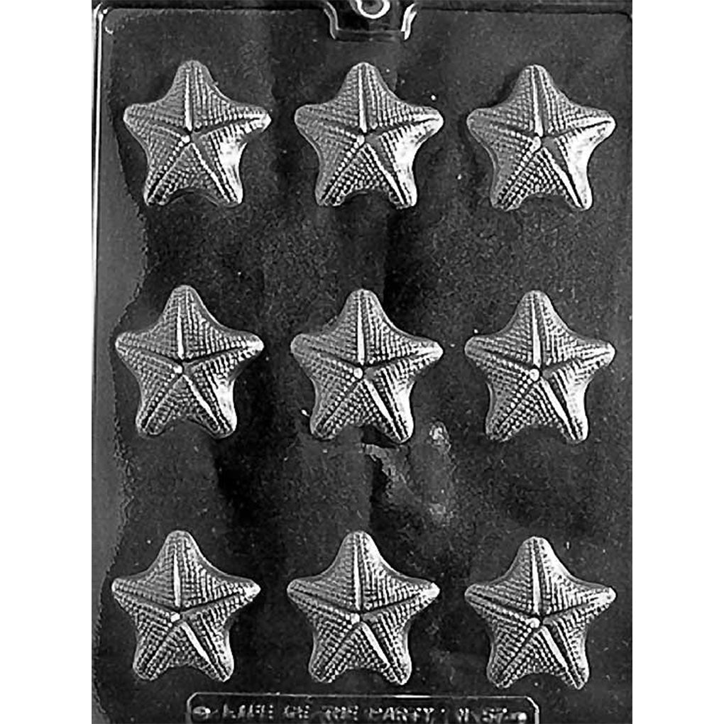 Clear Starfish Shell Chocolate Mold photographed against a black background with nine small starfish-shaped cavities featuring textured ridges.