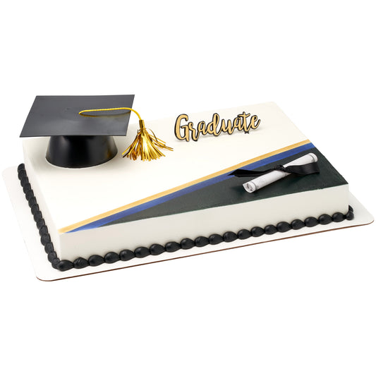 White graduation sheet cake with a black mortarboard cap and gold tassel on top, a gold “Graduate” script pick, and a rolled diploma tied with a black ribbon, with diagonal black, blue, and gold accent stripes.