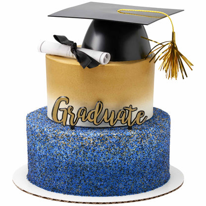 Tiered cake with a blue sprinkle-covered bottom tier and a gold-ombre top tier, finished with a black graduation cap and gold tassel, a rolled diploma tied with a black ribbon, and a gold “Graduate” script pick.