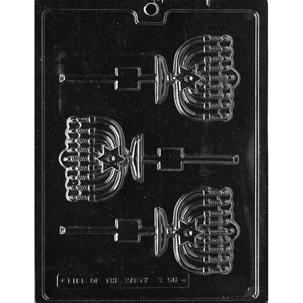 Clear plastic chocolate lollipop mold with three menorah-shaped cavities, featuring detailed branches, candle shapes, and stick channels, shown on a dark background.