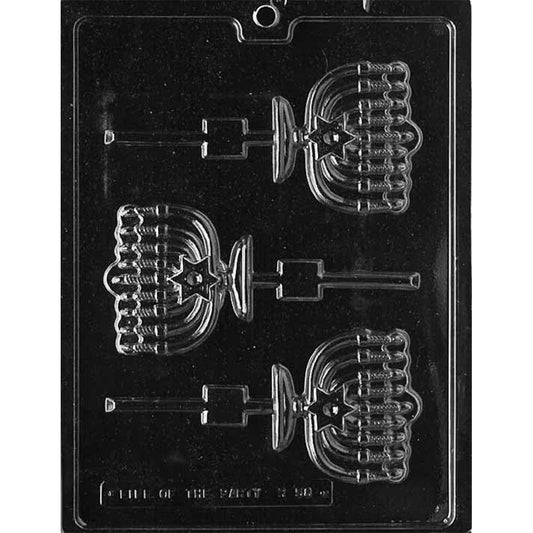 Clear plastic chocolate lollipop mold with three menorah-shaped cavities, featuring detailed branches, candle shapes, and stick channels, shown on a dark background.