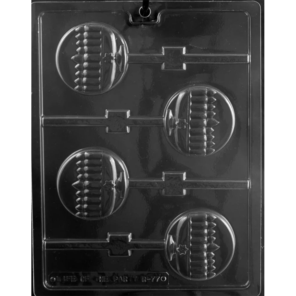 Clear plastic chocolate lollipop mold photographed on a black background, featuring four round lollipop cavities embossed with a menorah design and connected stick channels.
