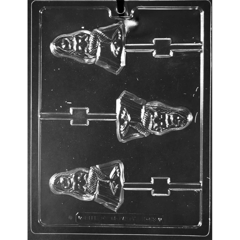 Clear plastic chocolate lollipop mold with three mermaid-on-a-rock cavities, each showing a mermaid figure with long flowing hair, scaled tail, and textured rock base, plus stick channels.