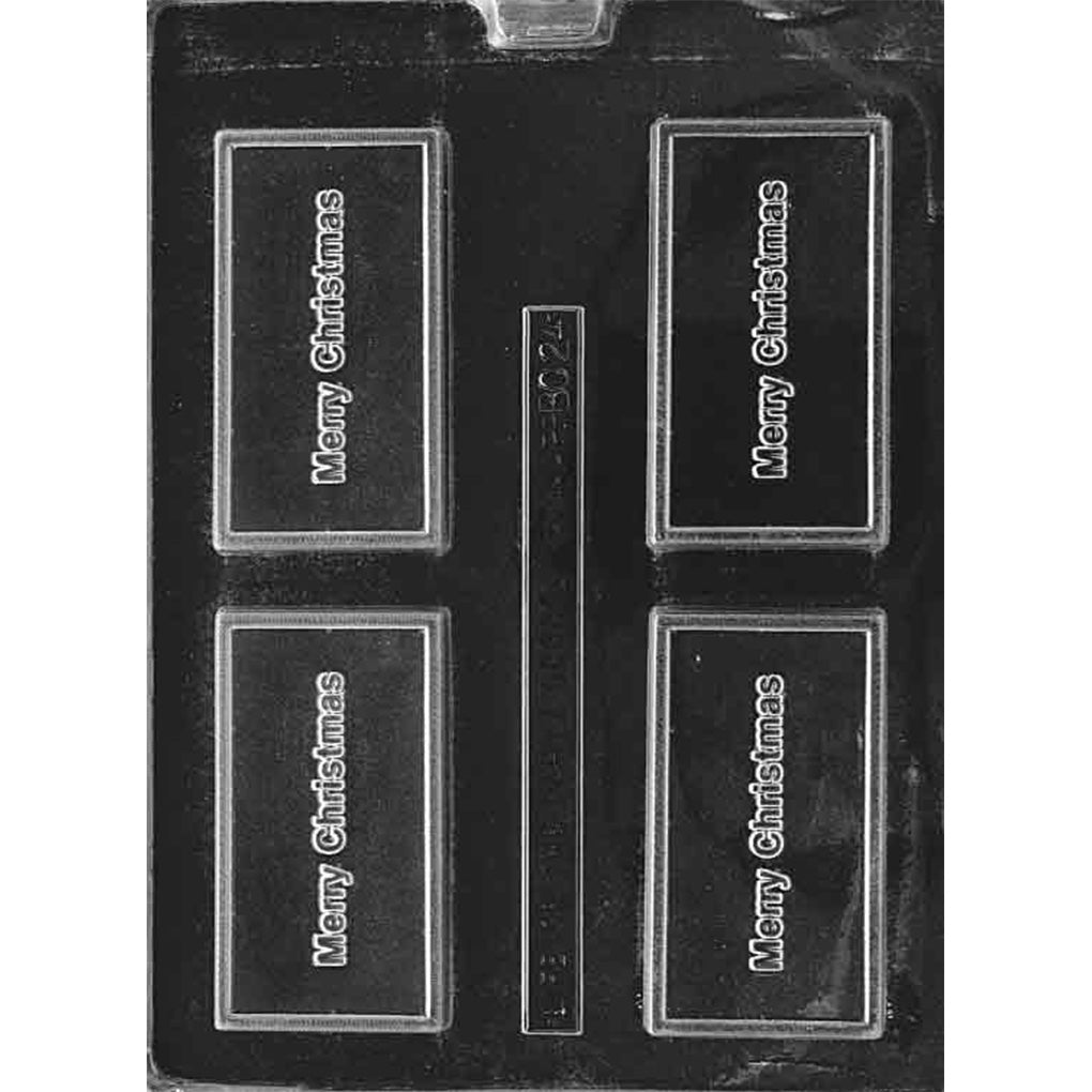 Clear plastic chocolate mold with four rectangular bar cavities, each with raised “Merry Christmas” lettering centered inside a bordered rectangle; shown on a dark background.