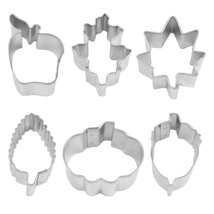 Close-up of six mini metal cookie cutters featuring fall-themed designs.