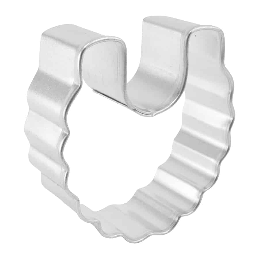 Side view of the mini baby bib cookie cutter, highlighting its depth and scalloped edges.