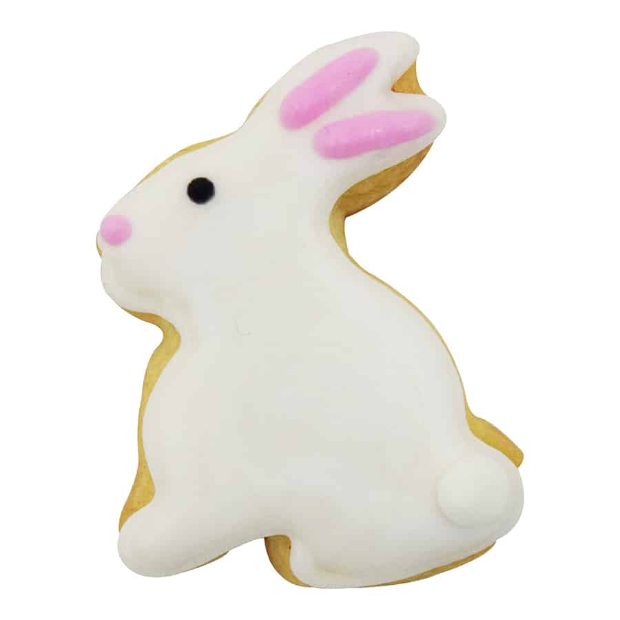 A decorated bunny-shaped cookie with white icing, pink ears, and a small round tail.