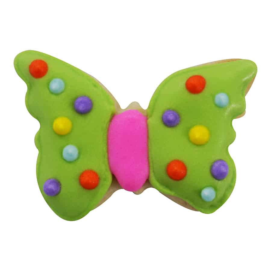 Decorated butterfly-shaped cookie with green icing, colorful polka dots, and a pink center.