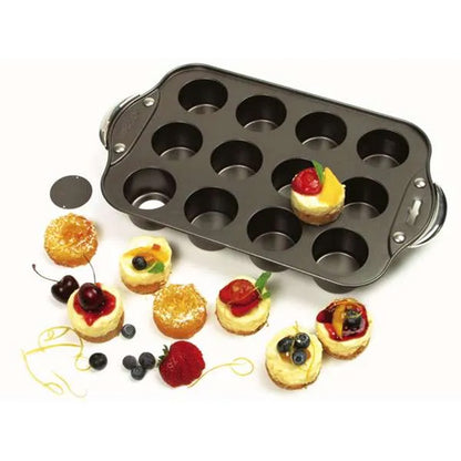 Mini cheesecake pan shown with assorted finished mini cheesecakes and fruit nearby.