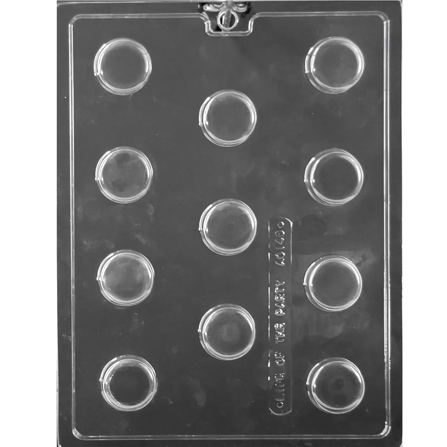 Clear plastic chocolate mold photographed on a dark background with multiple small round cavities arranged across the sheet for making mini chocolate covered cookie treats.