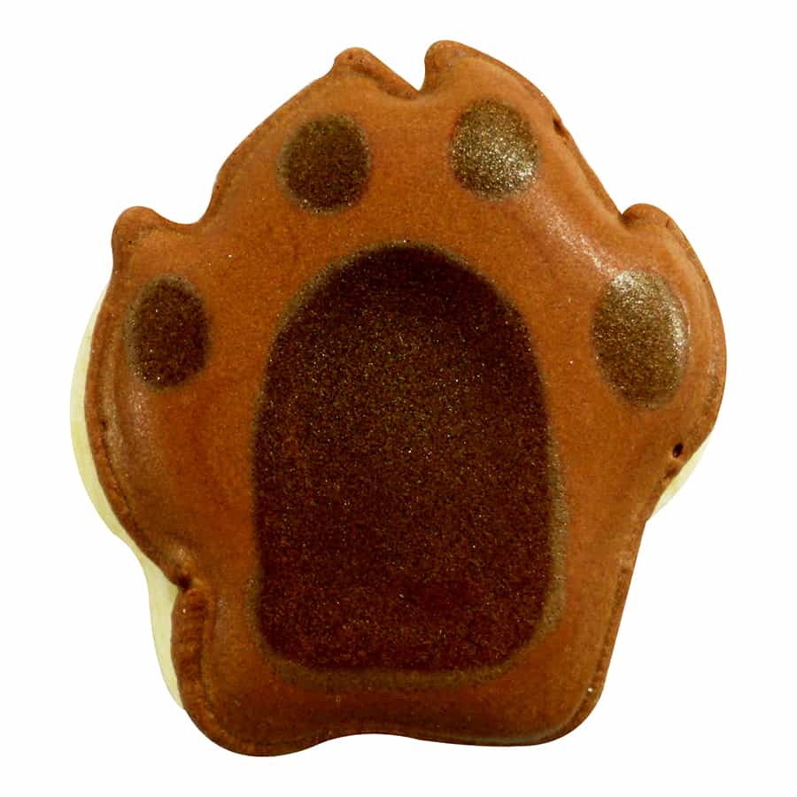 Decorated paw print cookie with brown icing, featuring a dark brown pad and four lighter brown toe accents.