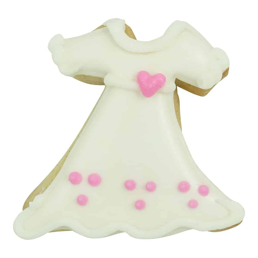 Decorated dress-shaped cookie with white icing, pink polka dots, and a small pink heart at the waist, made using the Mini Dress Cookie Cutter.