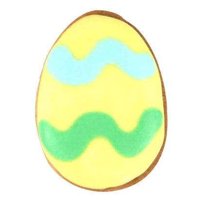 Decorated Easter egg cookie with pastel yellow icing and wavy blue and green patterns.