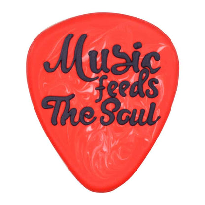 Decorated guitar pick-shaped cookie with red icing and the phrase 'Music feeds the soul' in black lettering