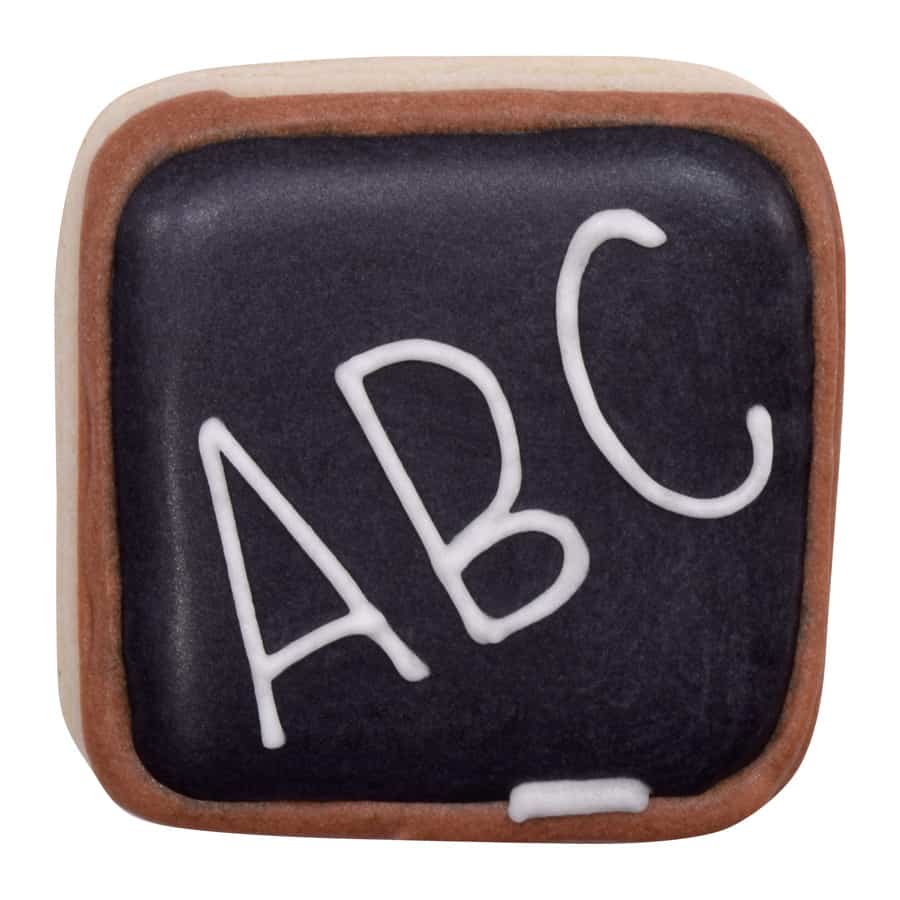 A decorated square cookie resembling a chalkboard, with "ABC" written in white icing.