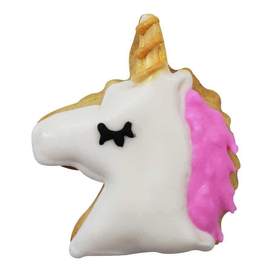 Decorated unicorn-shaped cookie with white icing, a golden horn, and a pink mane.