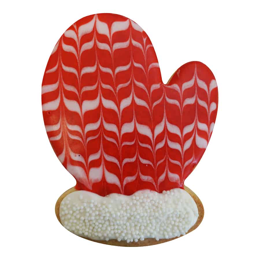 Red mitten cookie with a white marbled icing pattern and a textured, sugar-coated cuff.