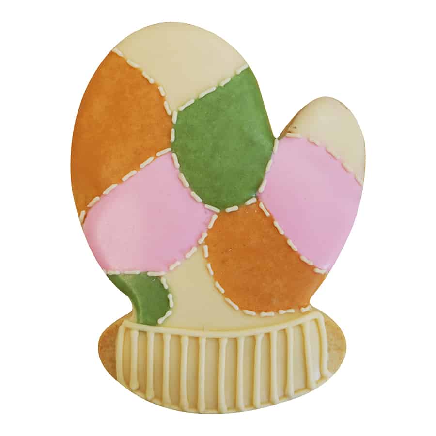 Decorated mitten cookie with a patchwork quilt pattern in soft pastel colors.