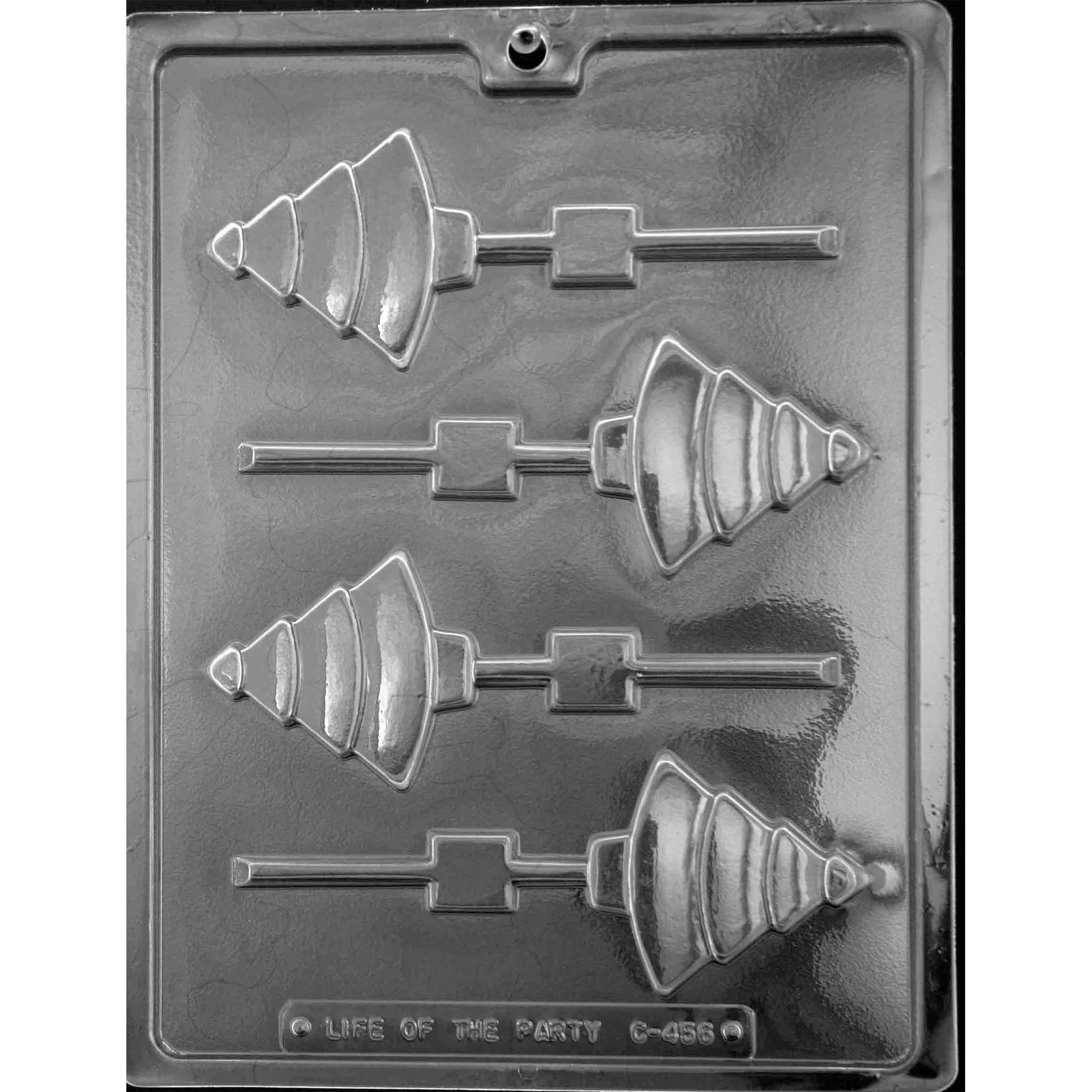 Clear plastic Christmas tree chocolate lollipop mold photographed on a dark background, showing four modern tree-shaped cavities with layered bands and built-in stick channels.