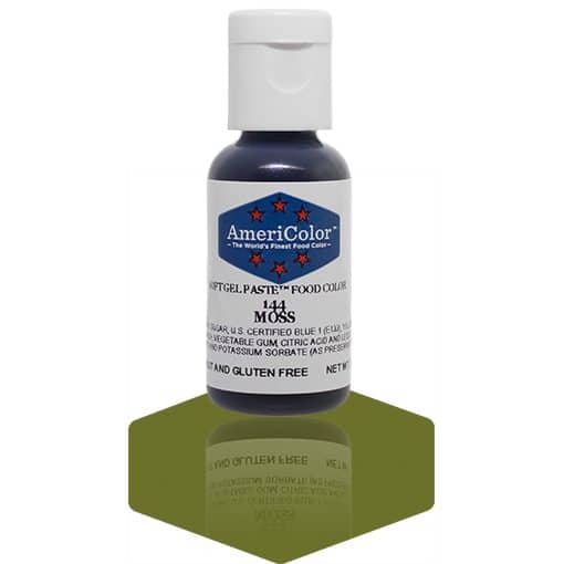 A bottle of AmeriColor Moss soft gel paste food coloring with a white cap and blue label featuring red stars, standing on a moss green reflective surface that mirrors the bottle.