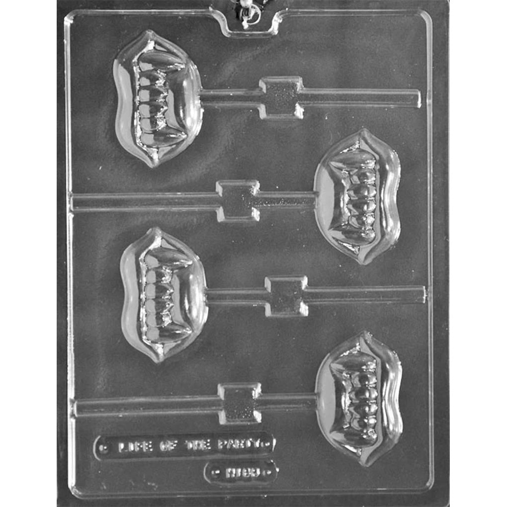 Clear plastic chocolate lollipop mold with four vampire fang-shaped cavities, each showing raised teeth details and a stick channel, on a dark background.