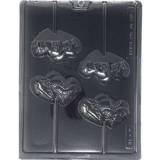 Clear Mr & Mrs wedding chocolate lollipop mold photographed against a black background, with four heart-shaped cavities featuring raised Mr & Mrs lettering and tuxedo and ornate wedding dress designs.